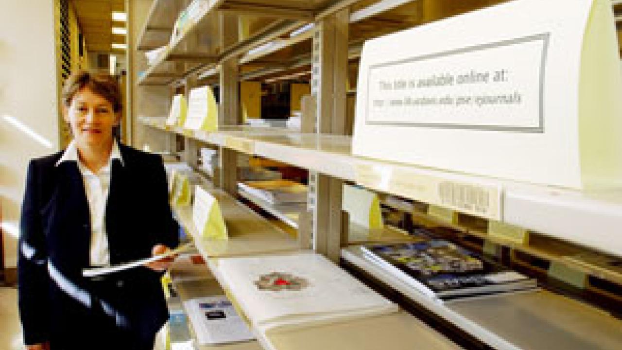 Physical sciences librarian Karen Andrews walks down journal aisles in her library &mdash; now sparse as a switch to online journals is realized  across campus. The libraries are working hard to retain the scholarly content of pricey print journals 