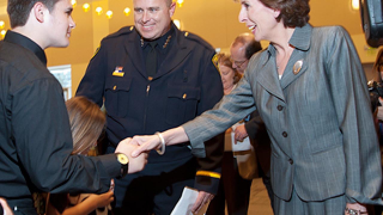 The chancellor shakes hands with Carmichael children.