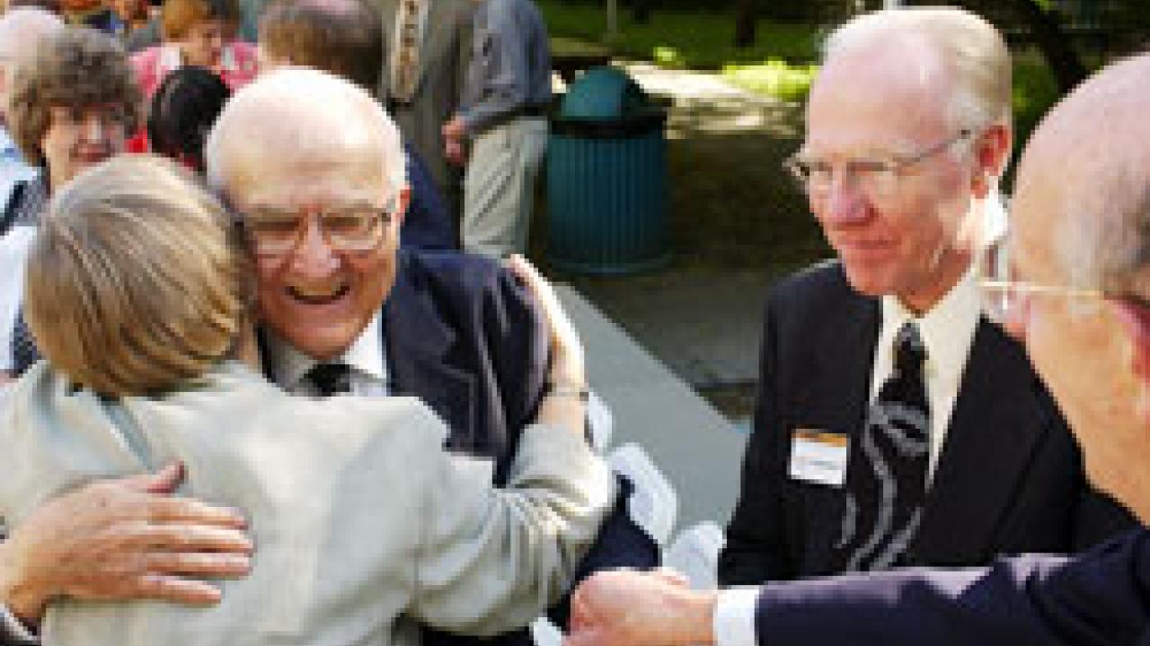 photo of John Kemper getting a hug  from Provost Virginia Hinshaw