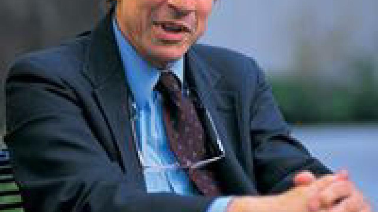 photo: man sitting with hands holding knee