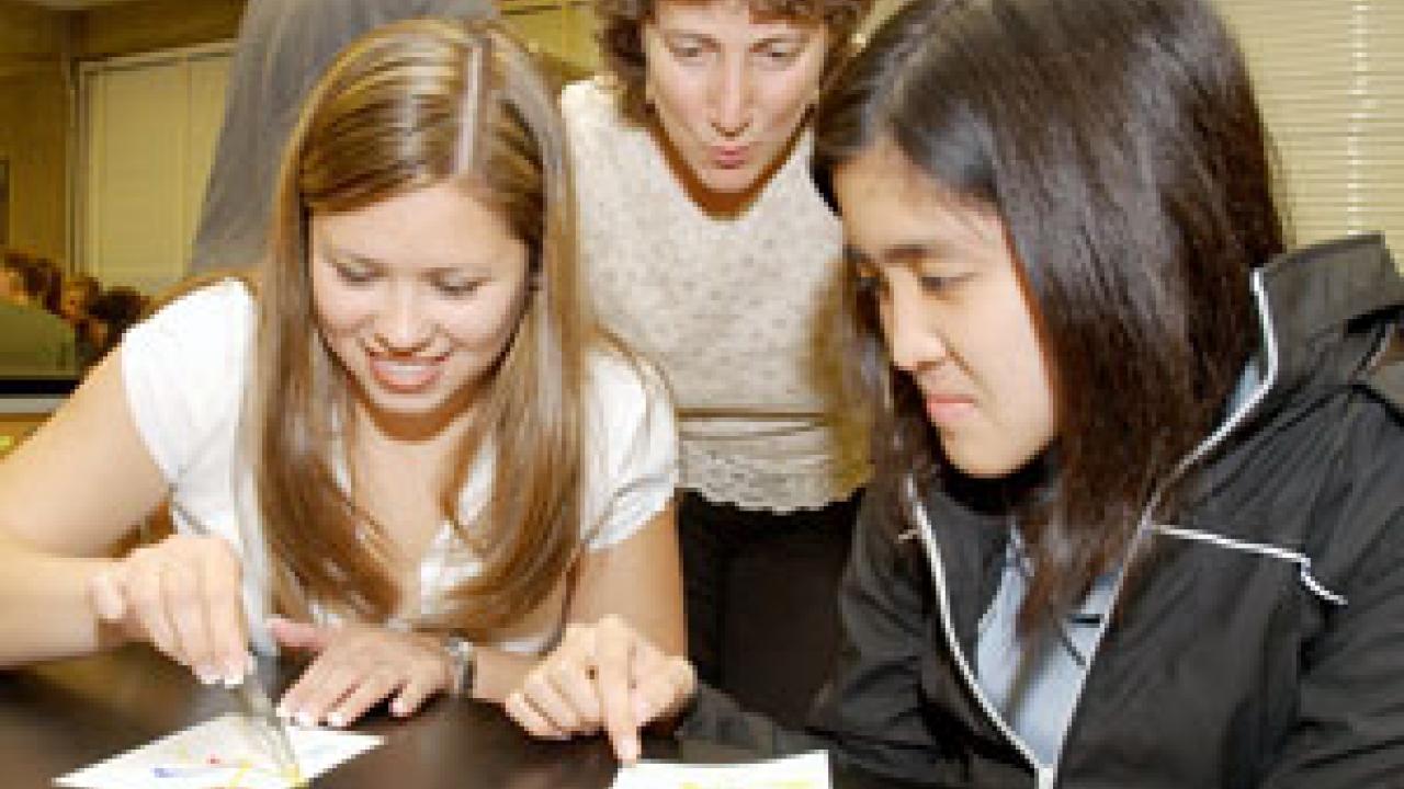 Entomology professor Diane Ullman, middle, takes a look at the Maggot Art of Kristle Hinkle and Parawee Lekprasert.