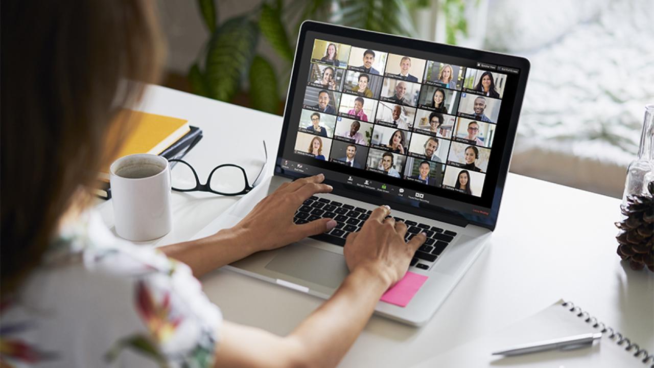 A student participates in an online class using a laptop