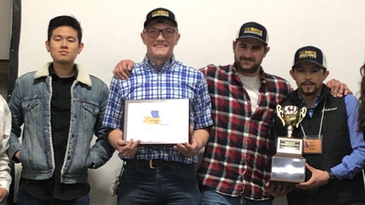 Meat Lab team with championship trophy and certificate