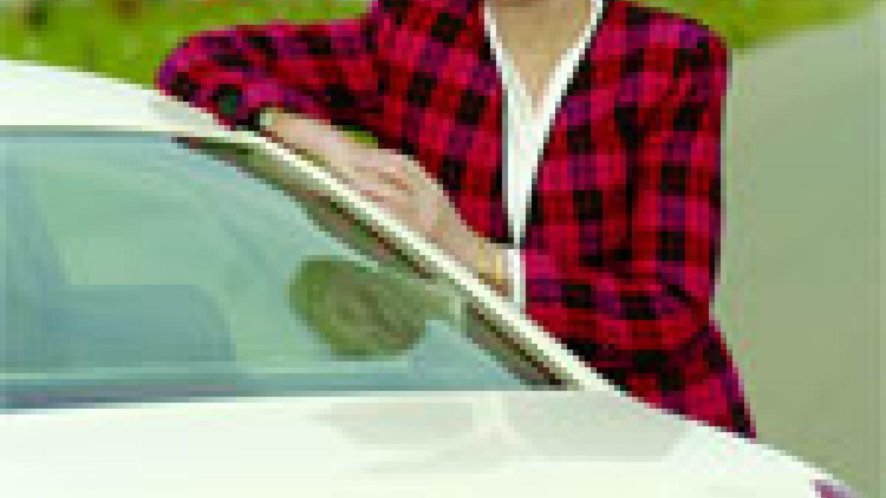 Photo: UC Merced Chancellor Carol Tomlinson-Keasey stands by her car with the Kolligan Library in the background.