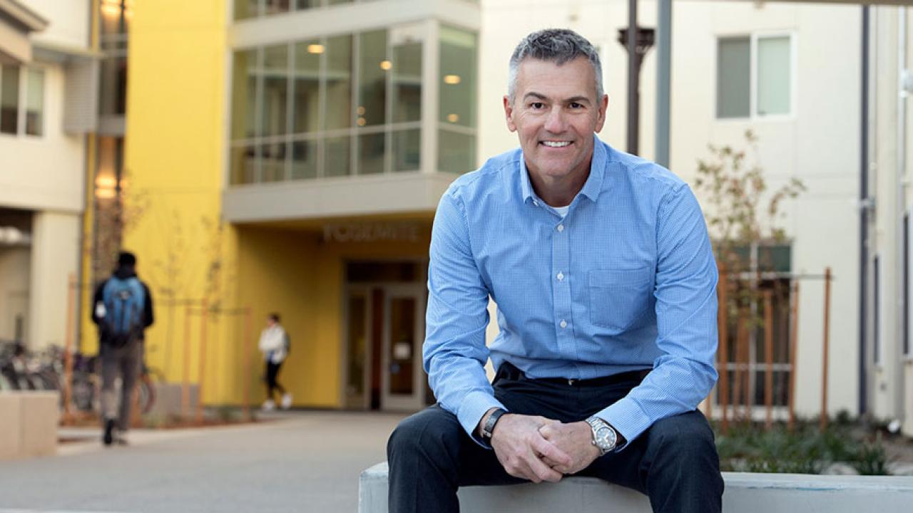Mike Sheehan sits in front of Yosemite residence hall.