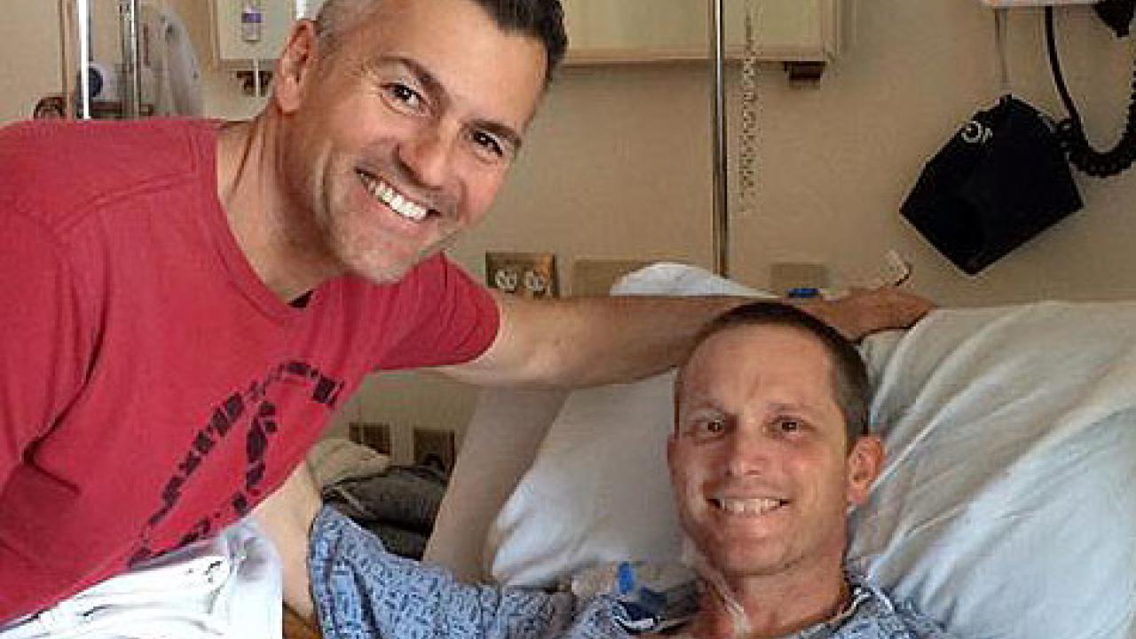 Photo: Mike Sheehan visits Brad Vernet at his hospital bed.