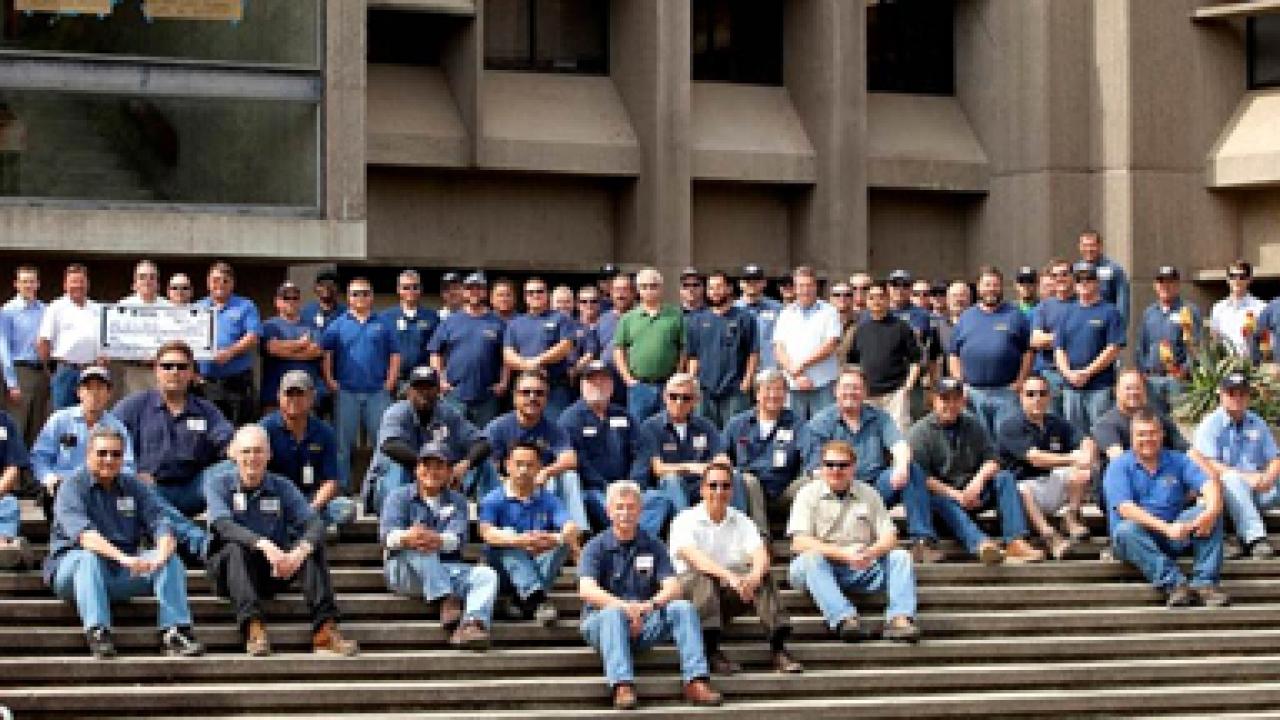 Photo: Building Maintenance Services who participated in the Briggs Hall retrofit, pictured on the Briggs Hall entry staircase