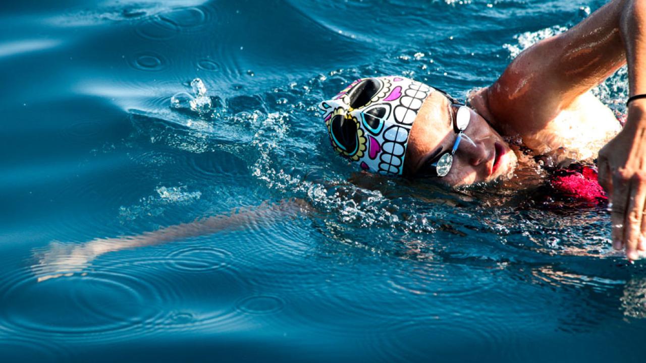 Woman swims the crawl stroke in crystal-blue Lake Tahoe.