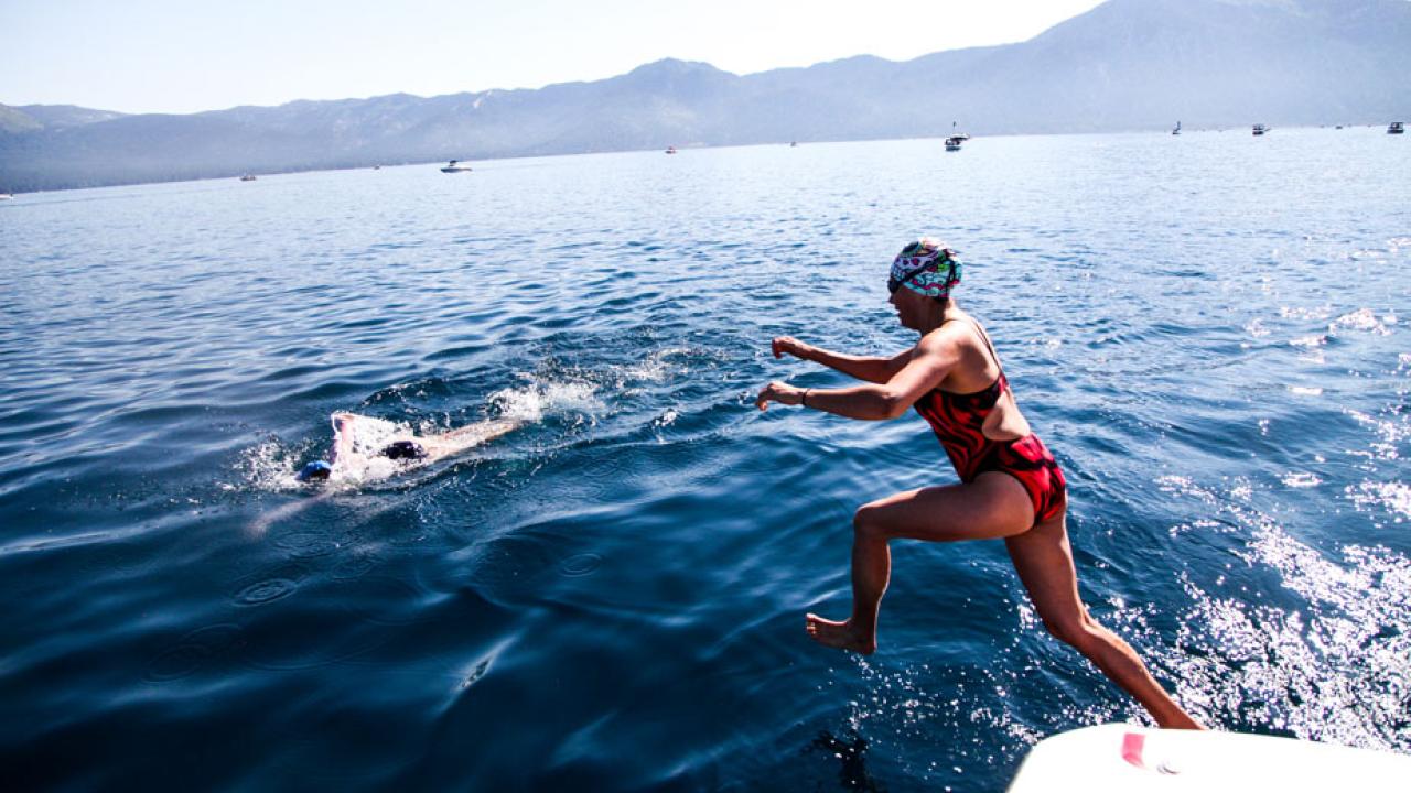 Swimmer jumps off boat.