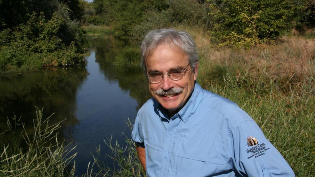 Photo: Peter Moyle foreground, waterway behind.