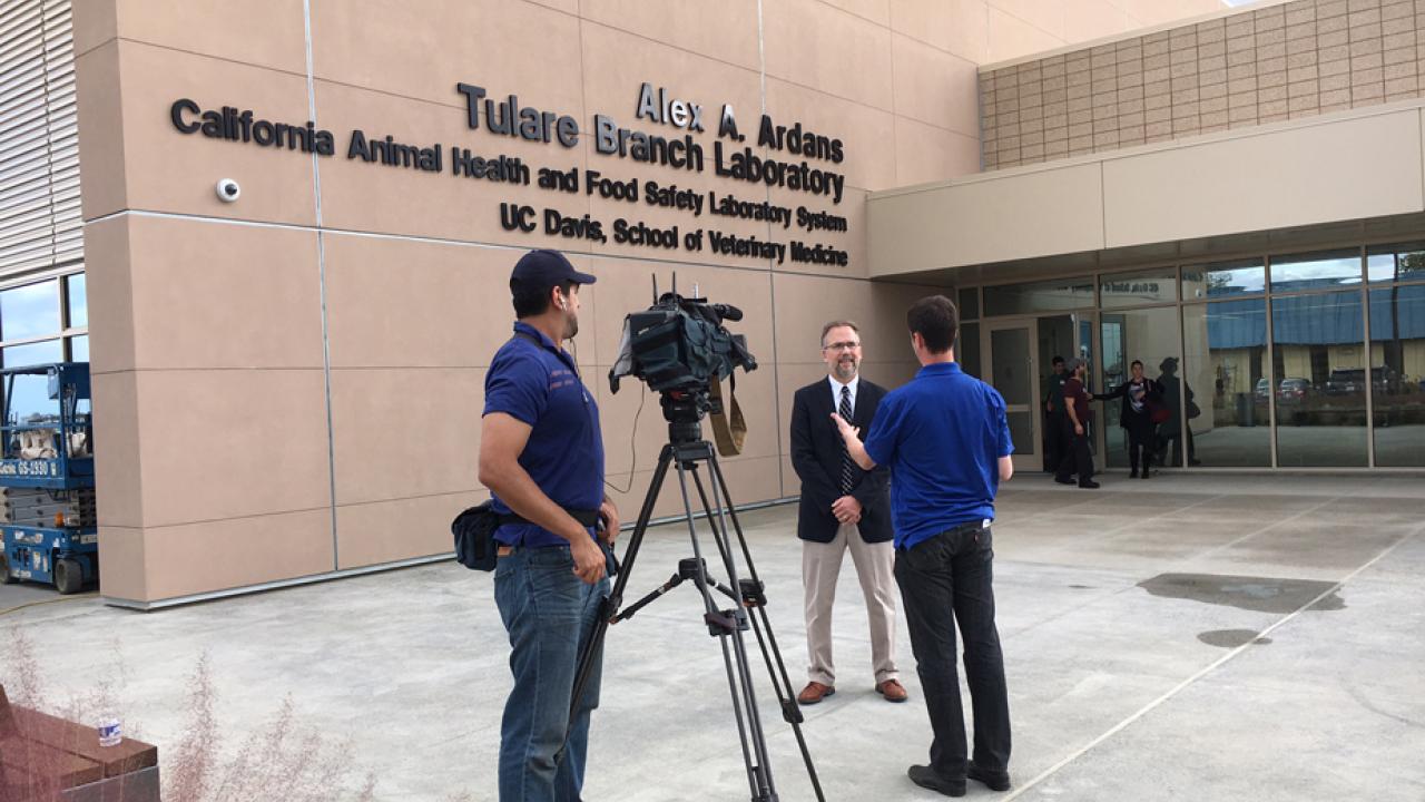 Photo: TV crew interviews a man in front of the new lab.