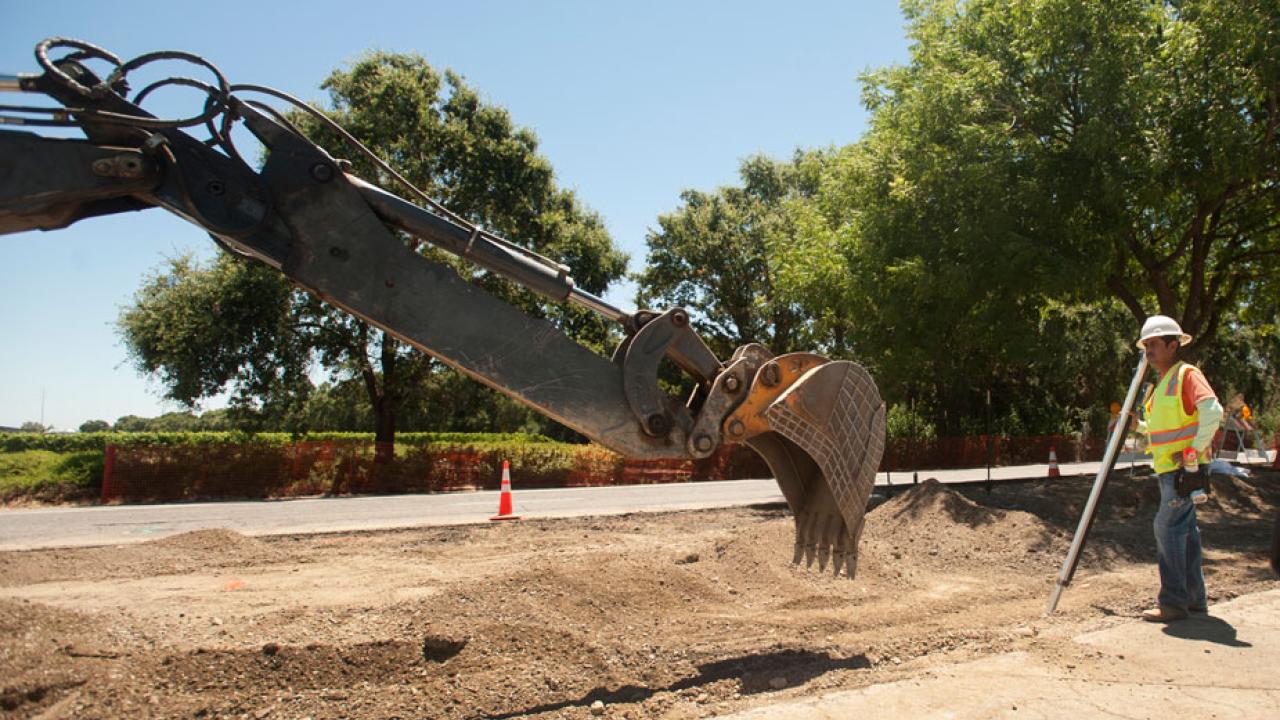 Backhoe works in the Old Davis Road median.