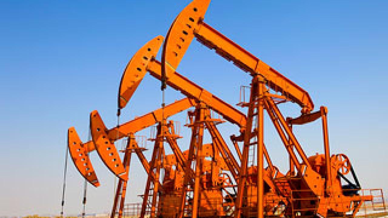 Photo of four derricks pumping oil