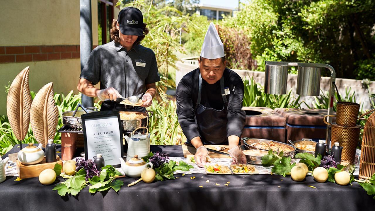 Chef places food on table.