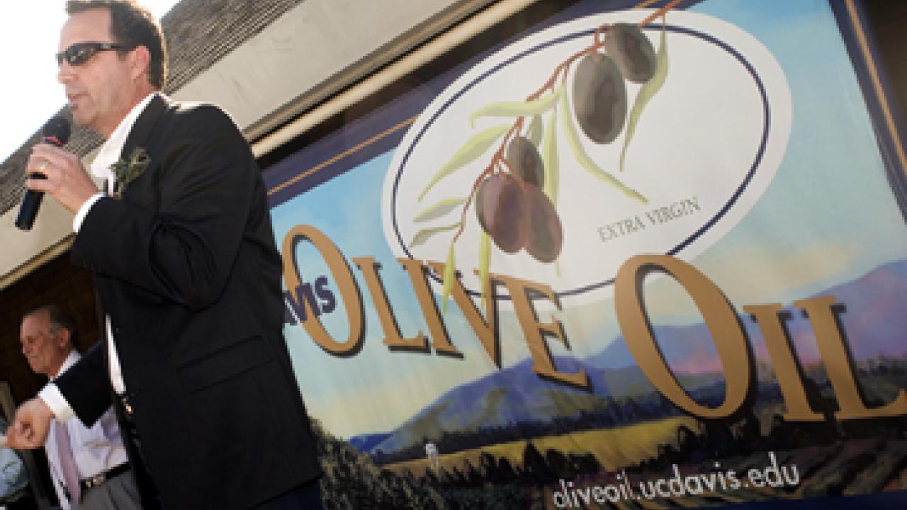 Sal Genito, director of the Buildings and Grounds Division, introduces this year's UC Davis olive oil varieties to a crowd of 500 people at the Silo C