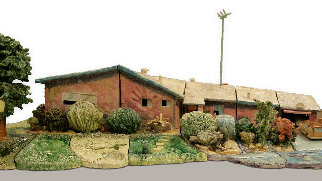 Glazed earthware scultpture of a house.