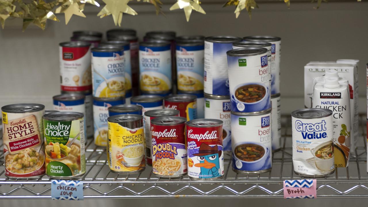 cans of food stacked on a shelf