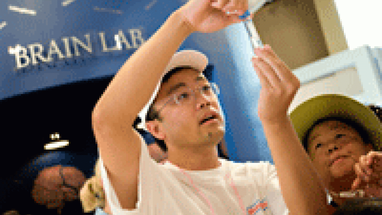 Dawei Lin, when he is not visiting the fair with his children, analyzes DNA at the university's Genome Center.