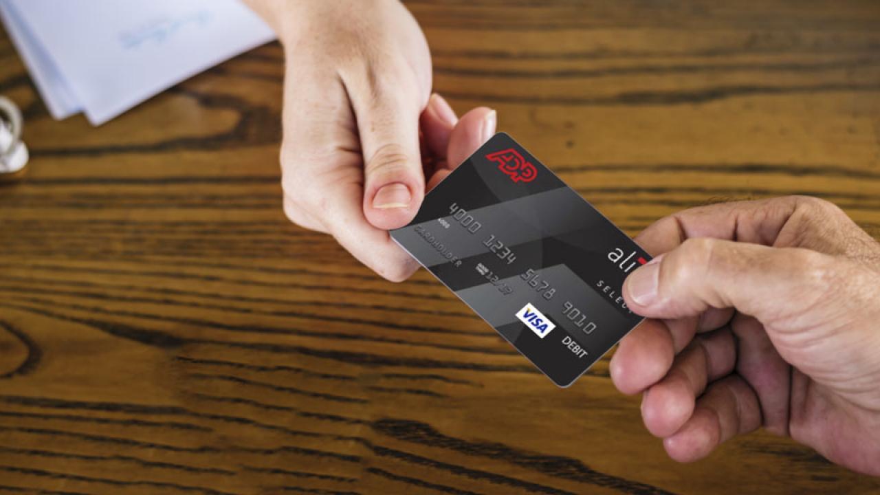 Pay card passes between two hands.