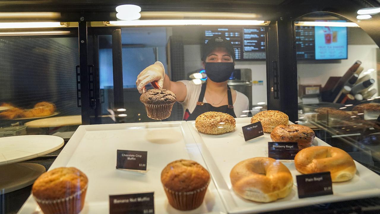 Student serves pastries in Peet's.