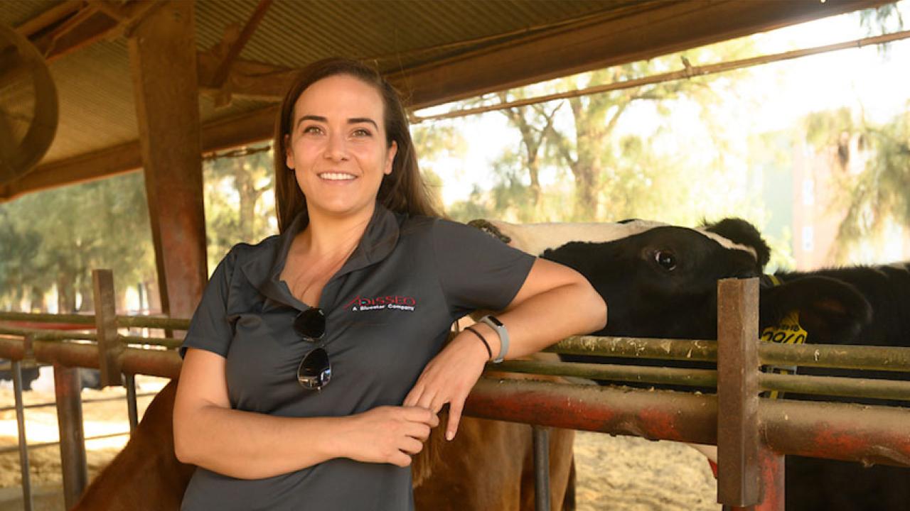 Closeup of woman with cow nudging her