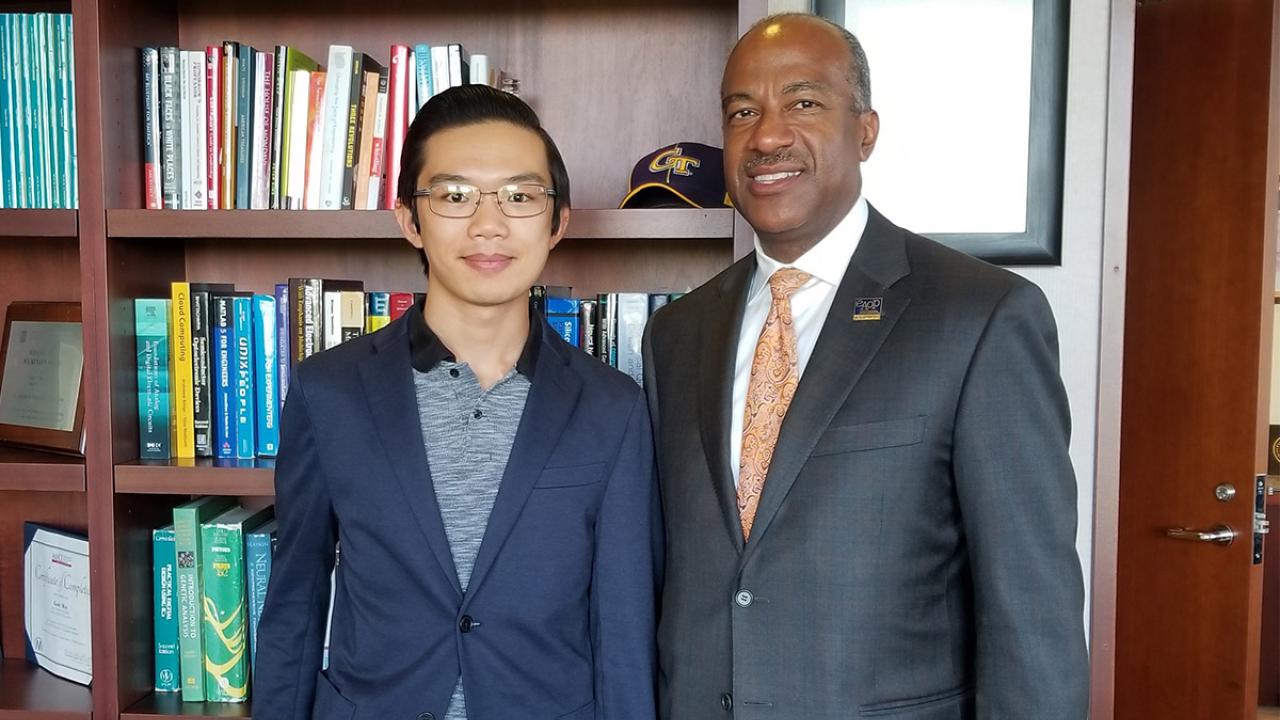 Richard Phouasalith and Chancellor Gary S. May.