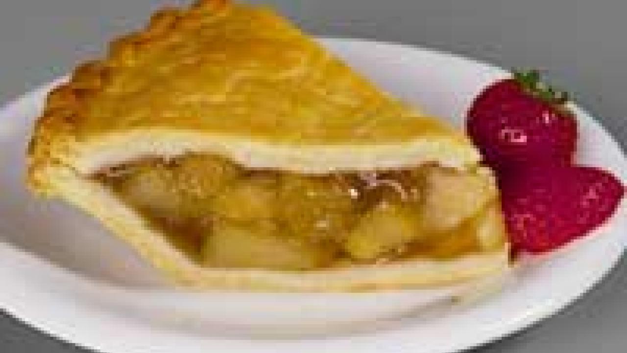 Photo: slice of apple pie with two strawberries