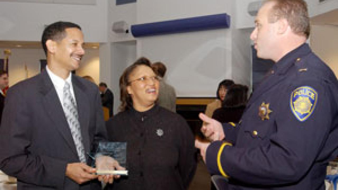 Medical Center telecommunications superintendent and twice-recognized award recipient, Michael Person, and his wife, Denise, chat with Police Lt. Matthew Carmichael during last week&rsquo;s ceremony.
