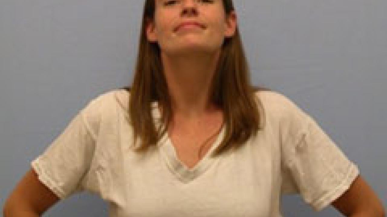 Photo: woman smiling with her hands on her hips and her chest expanded