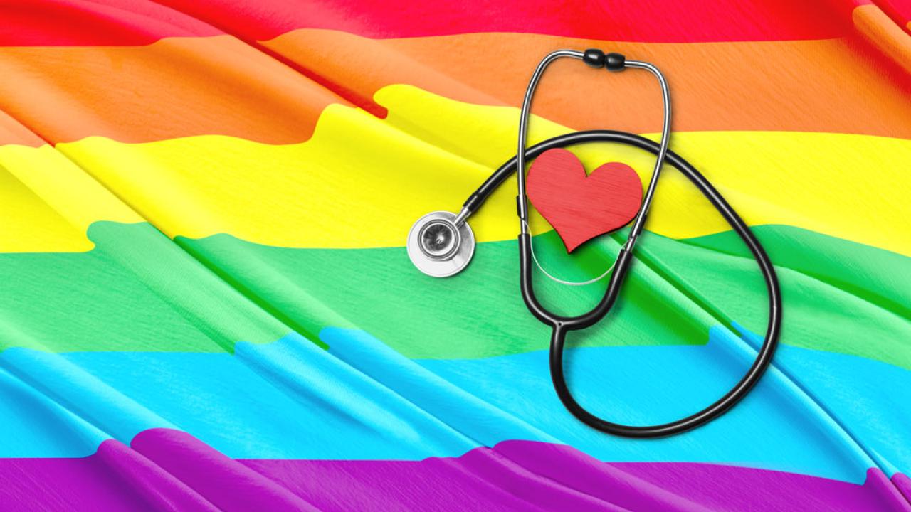 Stethoscope and heart atop rainbow flag