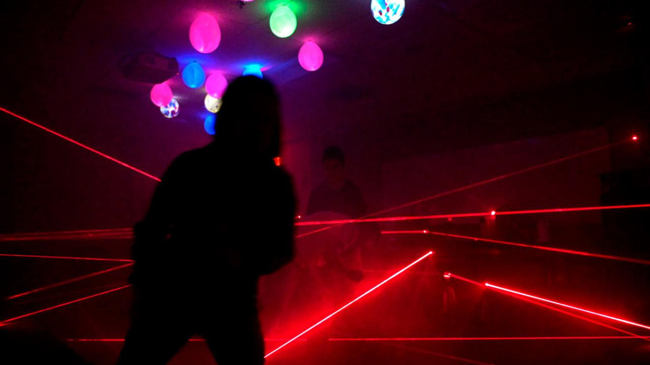 Red laser beams comprise a maze.