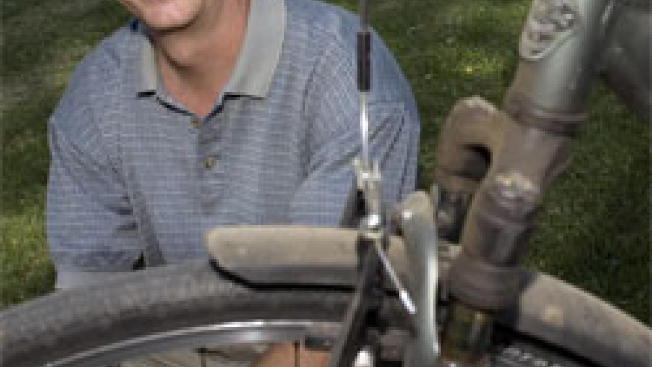 photo: portrait of man behind dusty bicycle