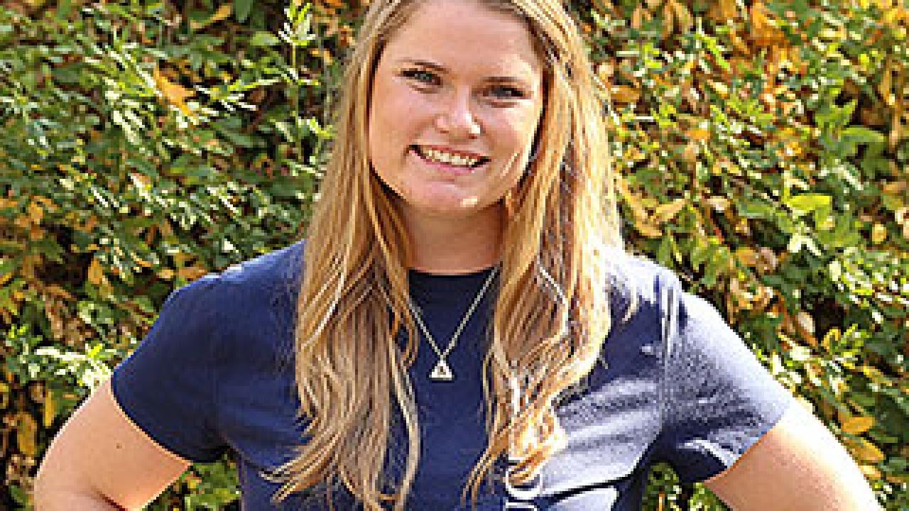 Woman in blue T-shirt posing