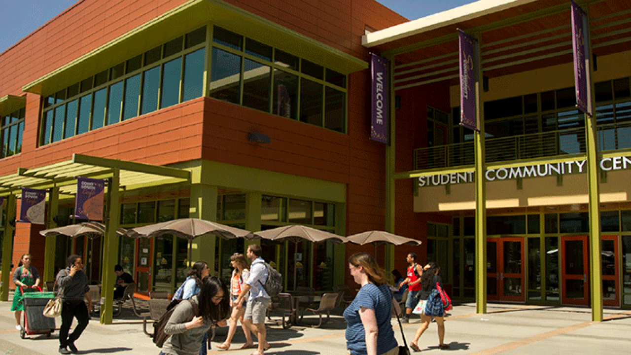 Student Community Center exterior, with people walking by