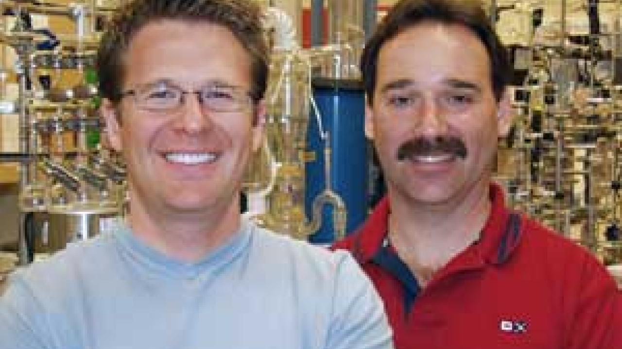 Photo: two men in a laboratory with much equipment