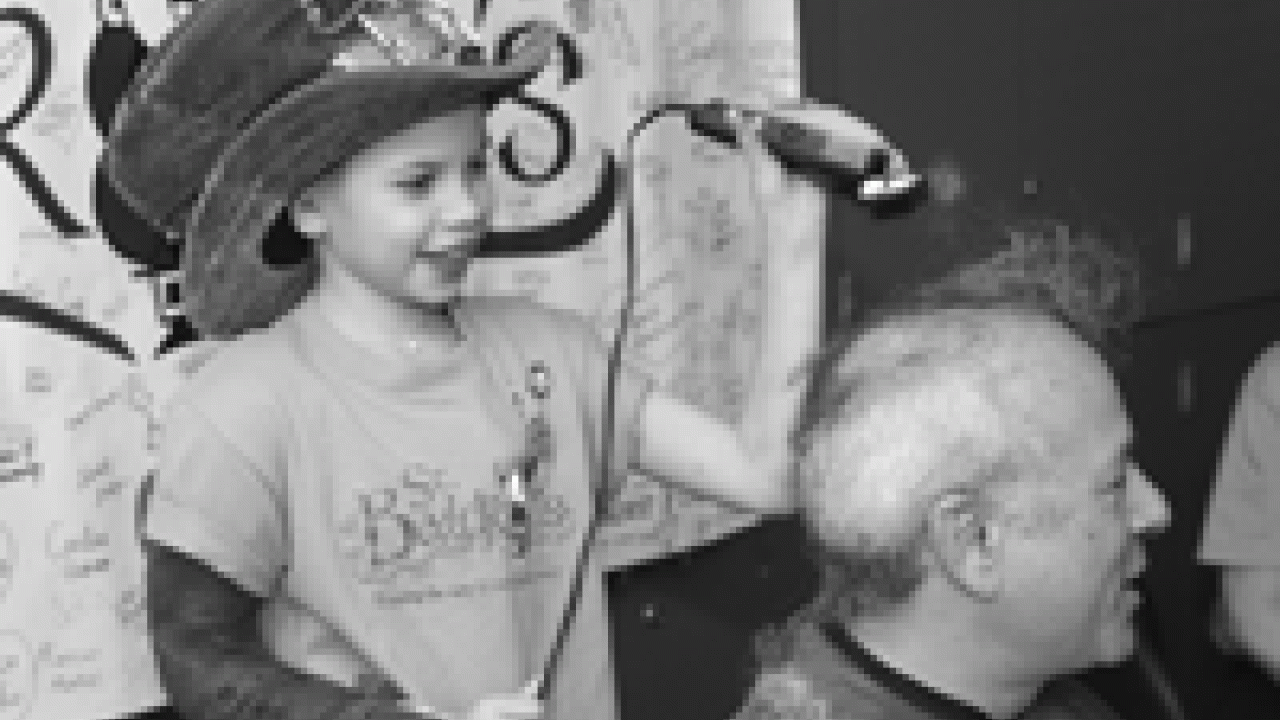 Francesca Arnaudo, left, a UC Davis patient who twice beat cancer and is alive today, shaved the head of Ted Zwerdling, an associate professor of pediatrics, at the 2005 St. Baldrick&rsquo;s  fundraising event. It was Arnaudo&rsquo;s idea to shave her h