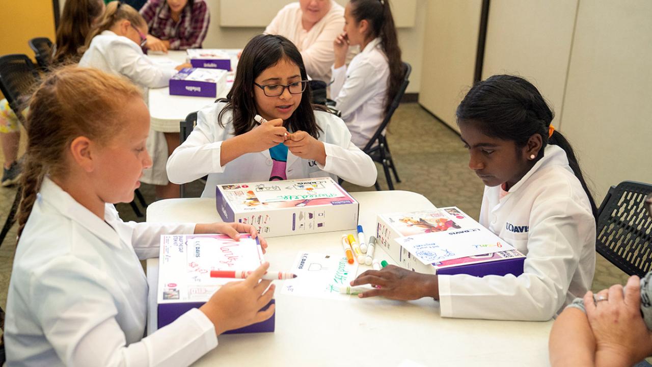 Young girls with computer-learning kits.