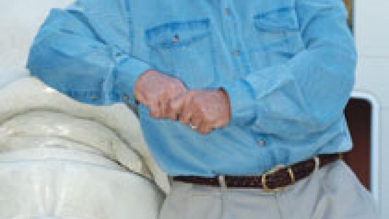 Man shaking woman's hand as a boy in between and another man to the side look on