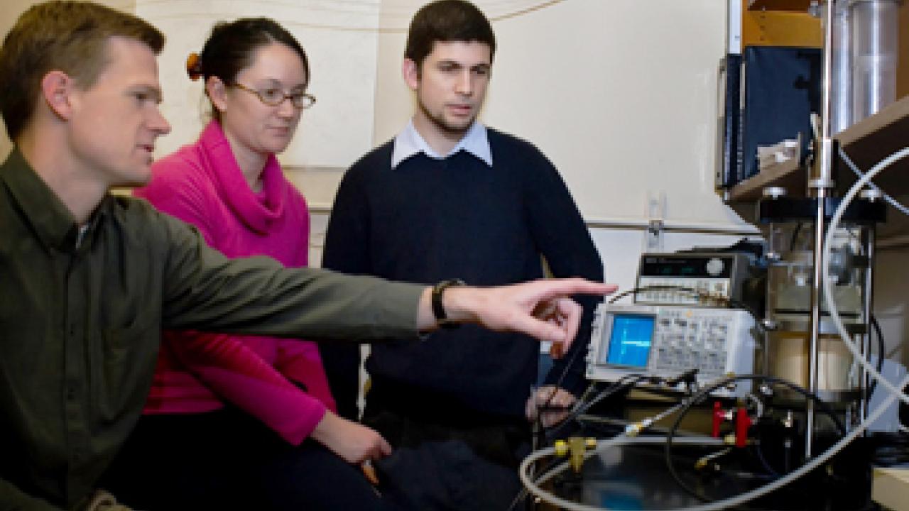 Assistant Professor Jason DeJong, left, and graduate students Brina Mortensen and Brian Martinez are researching a method of strengthening the soil un
