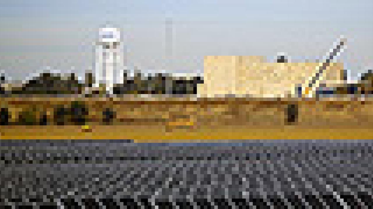 Solar panels with university in the background