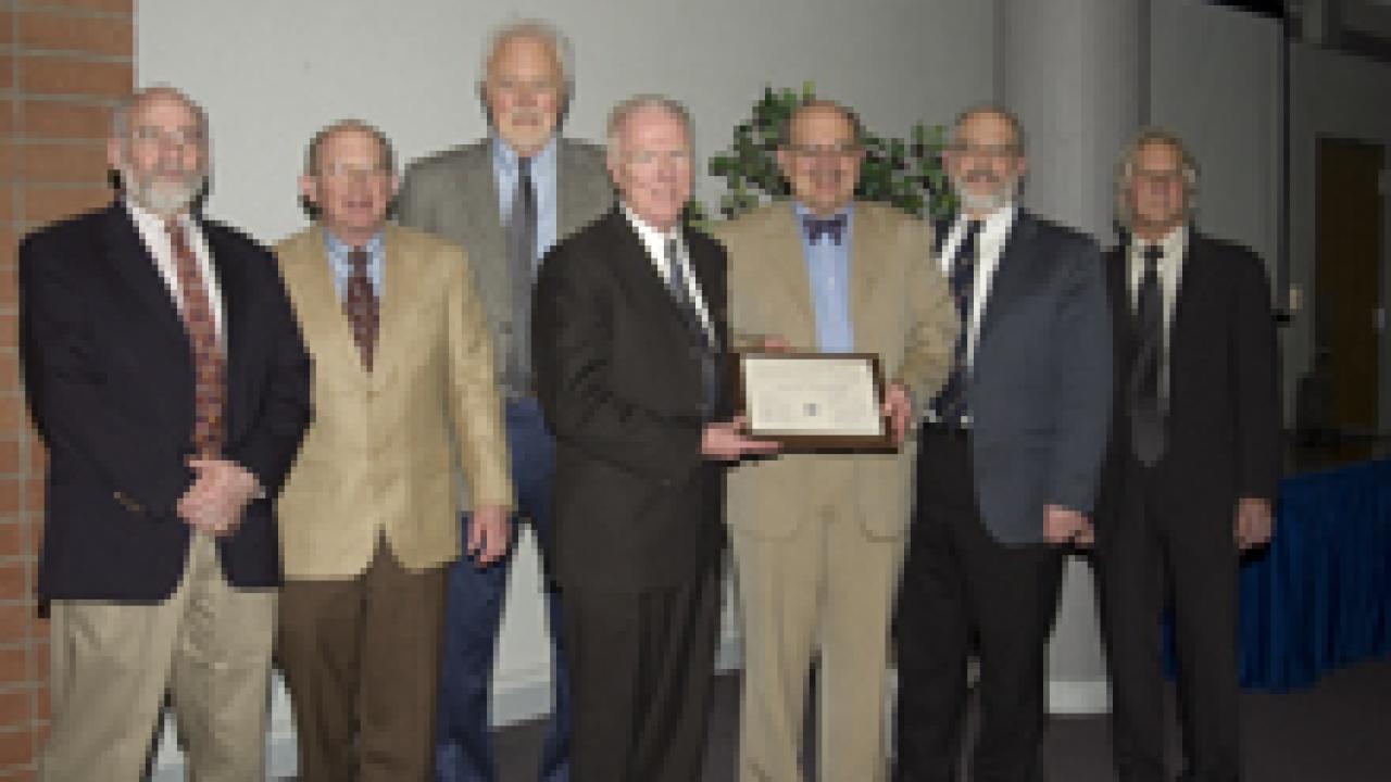 Larry Vanderhoef, center, accepts a certificate of appreciation from Academic Senate Chair Bob Powell, flanked by five former senate chairs on Feb. 24. From left: Lawrence Coleman (senate chair 1995-97), Dan Simmons (1991-93 and 2004-06), John V