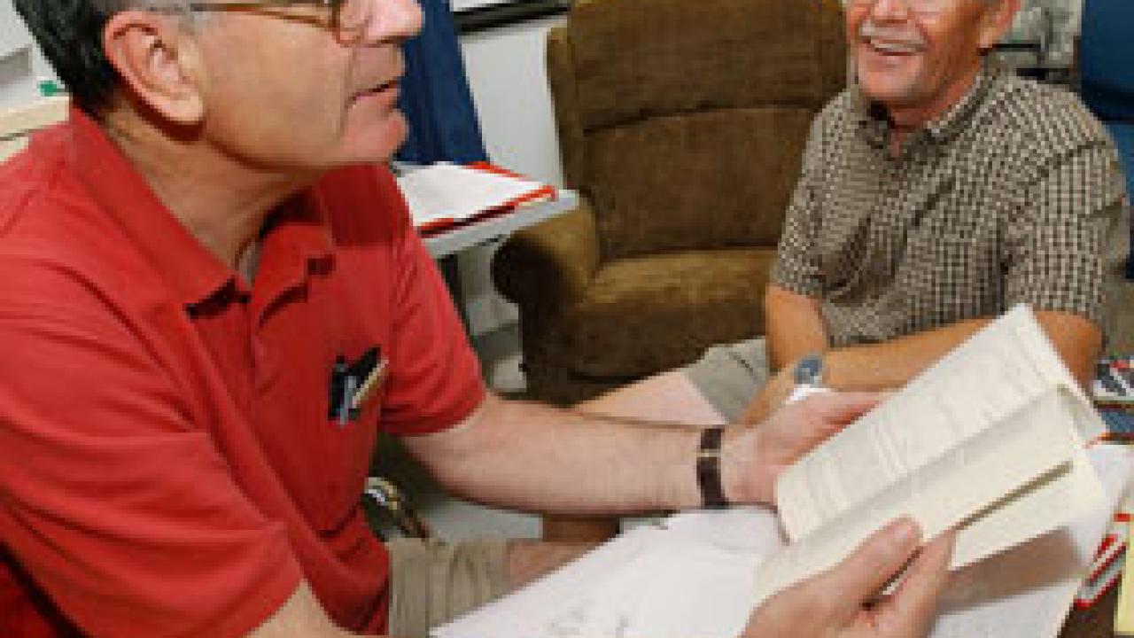 Professors Walt Stone, left, and Bob Huckfeldt talk about events that give rise to political partisanship as they turn through the pages of Huckfeldts new book, Political Disagreement: The Survival of Diverse Opinions Within Communication Netwo