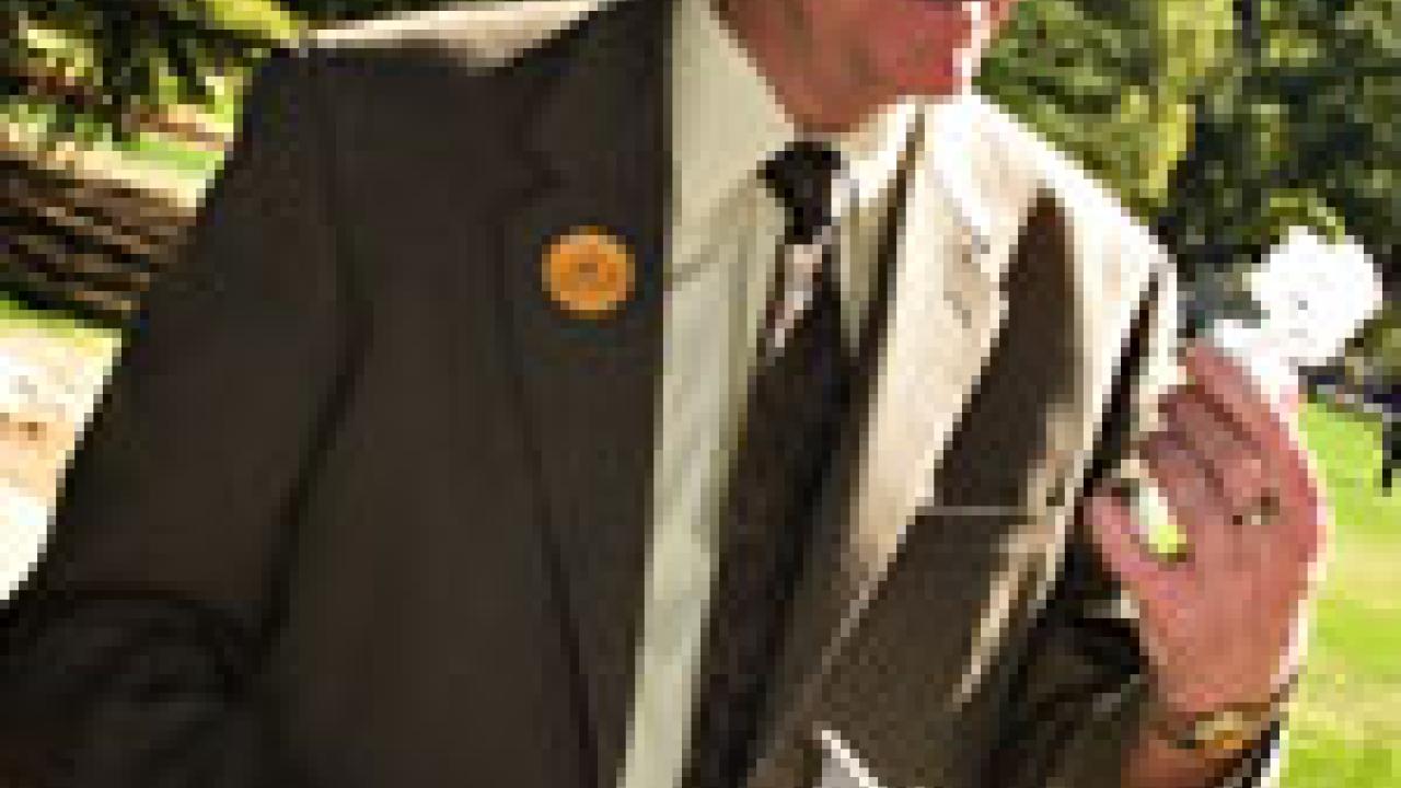 FRONT: Student Angela Capoccia picks out fresh produce from the Vang Farm&rsquo;s stand at the Farmers Market in the East Quad during Sustainability Day. INSIDE: Chancellor Larry Vanderhoef examines the energy efficient light bulbs that were handed 