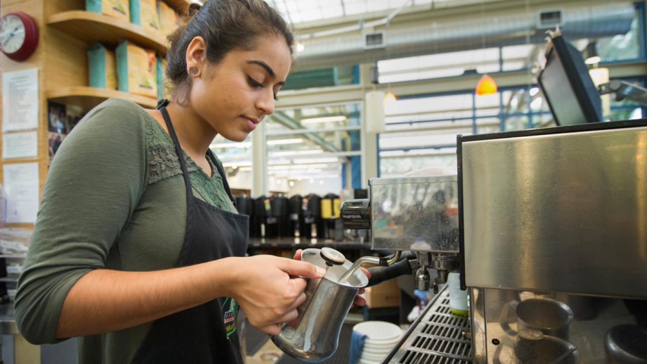 Photo: Plant sciences major Yasmeen Haider prepares a coffee drink at the Coffee House.