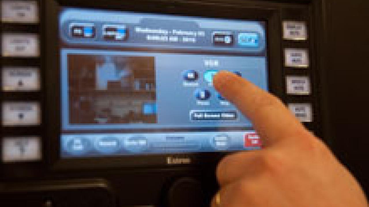 Audio visual manager Joe Kelley demonstrates how to use a new computer system to service classrooms remotely. The campus is evaluating this technology in three classrooms.