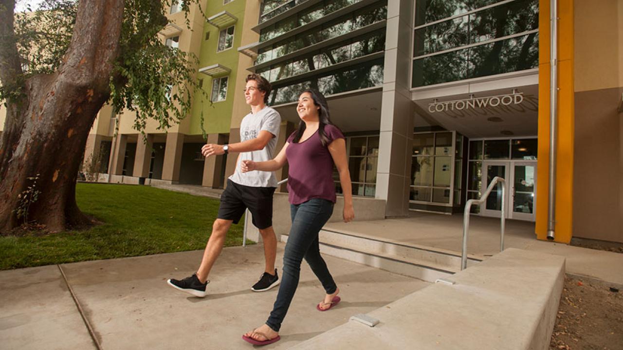 Two students walking in front of new Cottonwood Hall