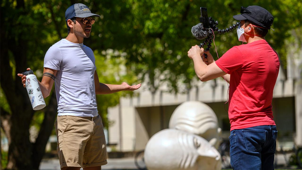 Man records video of tour guide.