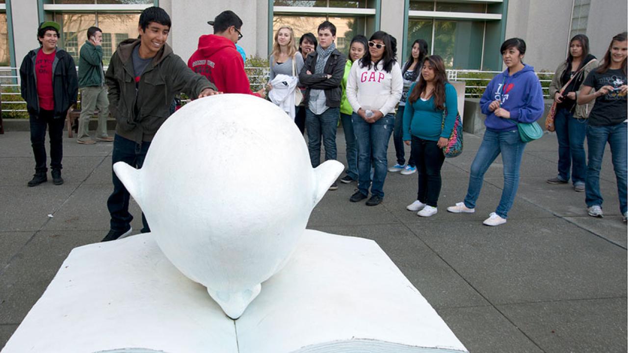 A tour group in front of the library