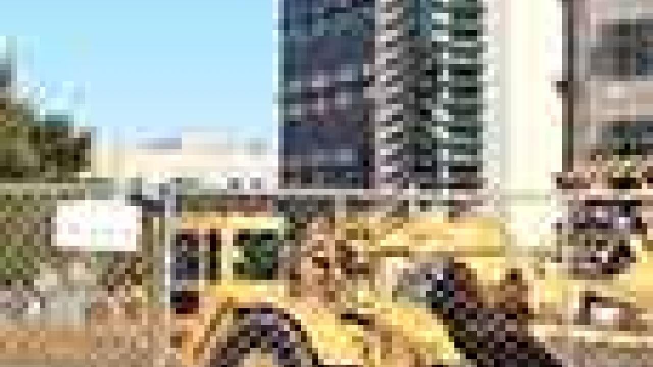 Tractor builds road in front of Vet Med 3B.