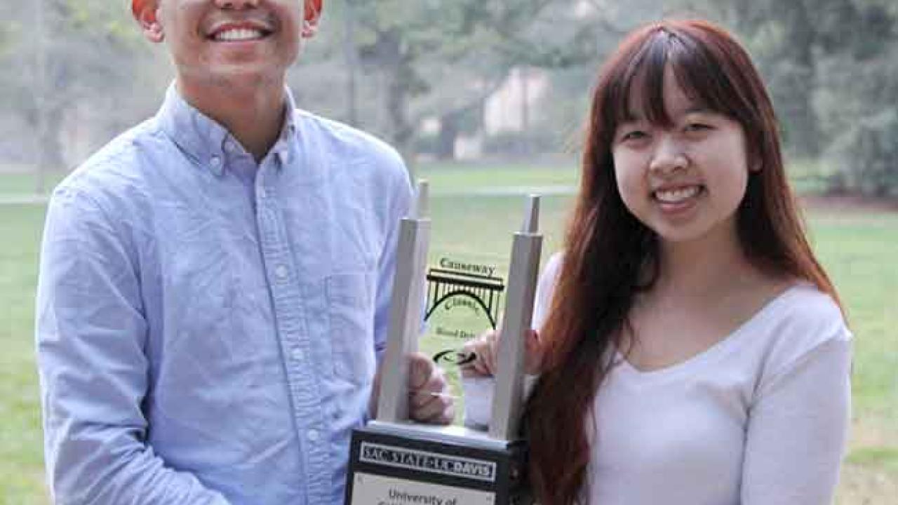 Photo: Two students hold the Causeway Classic Blood Drive perpetual trophy.